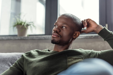 portrait of young pensive african american man looking awayの写真素材