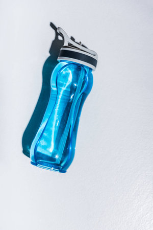 top view of sports bottle with water on greyの写真素材