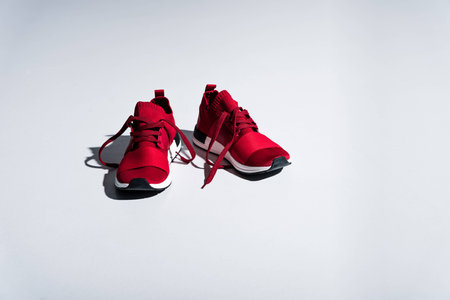 close-up view of red sneakers isolated on greyの写真素材