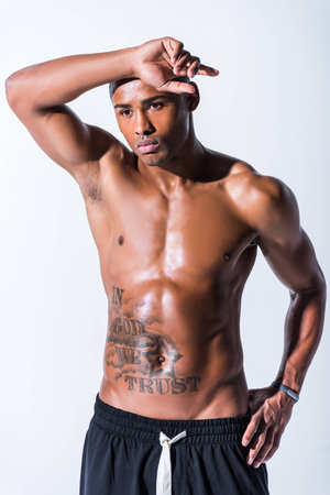 handsome shirtless muscular african american sportsman posing isolated on greyの写真素材
