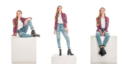 full length view of girls in checkered shirts and jeans posing isolated on whiteの写真素材