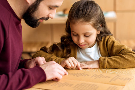 father and daughter choosing food in menuの写真素材