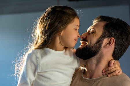 happy father and daughter touching with nosesの写真素材