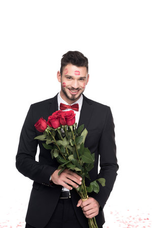 man with lips traces on face holding bouquet of roses isolated on white, valentines day conceptの写真素材