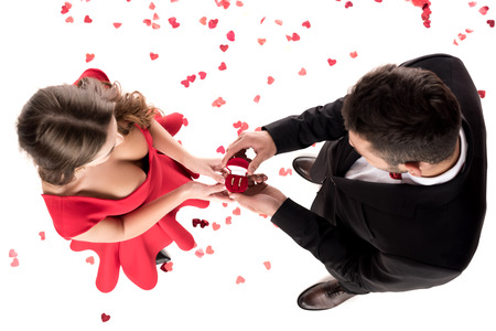 overhead view of boyfriend proposing girlfriend isolated on white, valentines day conceptの写真素材