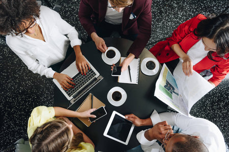 top view of group of business partners working together at cafeの写真素材