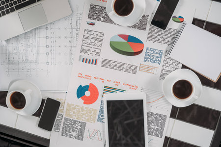 top view of business documents on workplace with digital devices and coffeeの写真素材