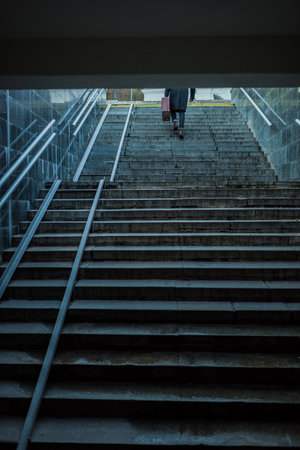lonely man walking upstairs out of undergroundの写真素材