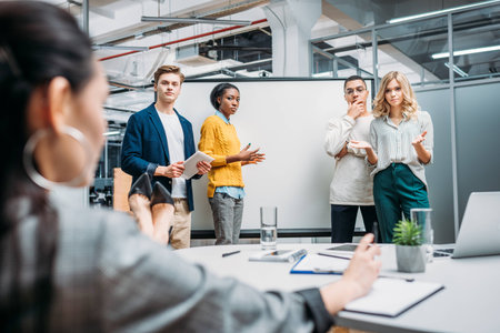 young multiethnic group of managers making presentation for lady bossの写真素材