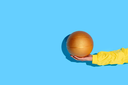 Cropped image of man hand with basketball ball in handの写真素材