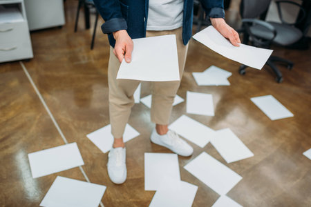 cropped shot of businessman with lot of paperworkの写真素材