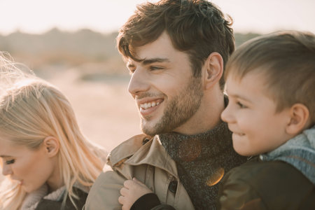 happy family with son spending time on sandy beachの写真素材