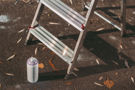 close up of ladder and can with colorful spray paint on asphaltの写真素材