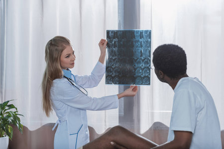 Doctor showing x-ray to african american patient in the clinic