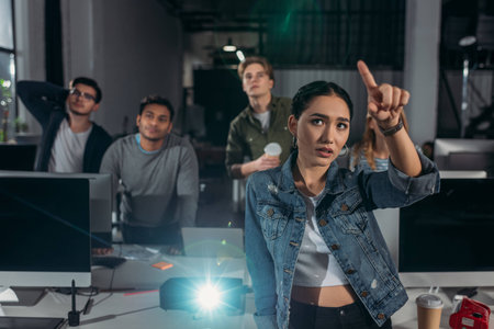 people watching presentation in modern office, woman pointing on screen