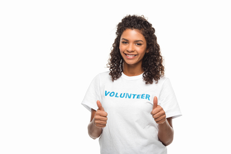 happy african american female volunteer showing thumbs up isolated on whiteの写真素材