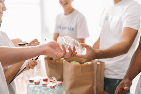cropped shot of volunteers with food and drinks for charityの写真素材