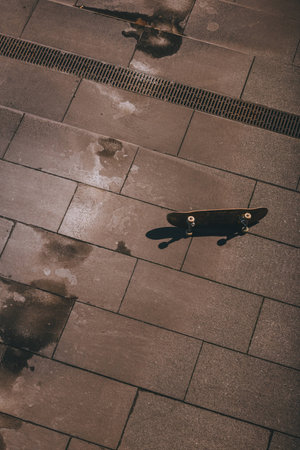 high angle view of skateboard laying on floor outdoorsの写真素材