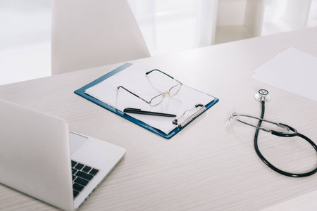glasses and pen on clipboard on working table in hospitalの写真素材