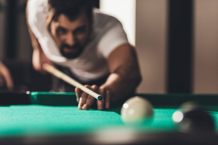 handsome caucasian man playing in poolの写真素材