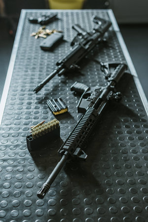 high angle view of rifles with bullets on table in shooting rangeの写真素材