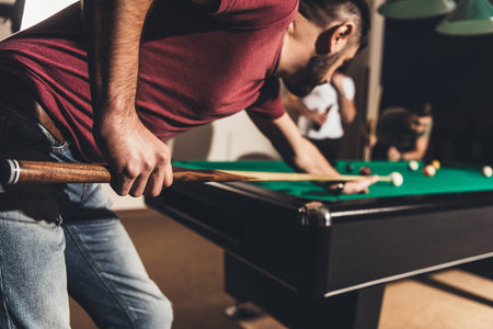 company of handsome men playing in pool