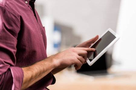 cropped image of businessman holding tablet