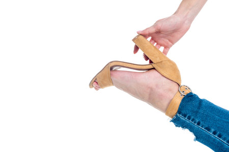 beautiful blonde girl posing in heel shoe, isolated on whiteの写真素材