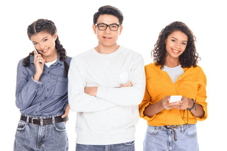 portrait of interracial teenagers with smartphones isolated on whiteの写真素材