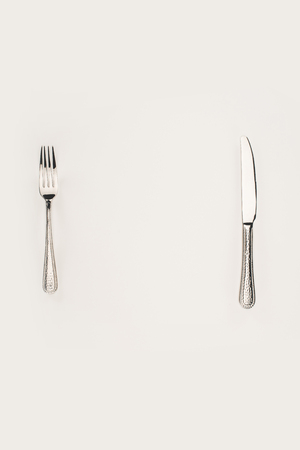 top view of fork and knife isolated on grey