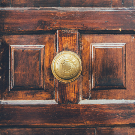 close-up shot of old wooden door with handle in middleの写真素材