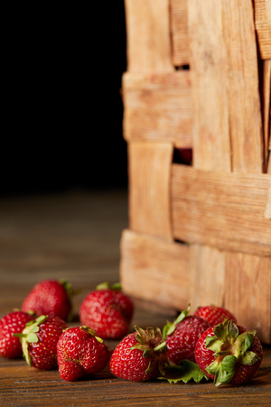 close-up shot of strawberries on wooden surface with rustic boxの写真素材