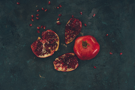 Top view of pomegranates on a dark concrete surface