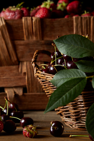 close-up shot of cherries and strawberries in basket and boxの写真素材