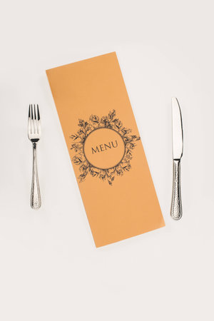top view of decorative menu and cutlery isolated on white