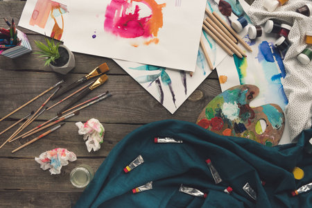 Top view of scattered painter sketches on a working tableの写真素材