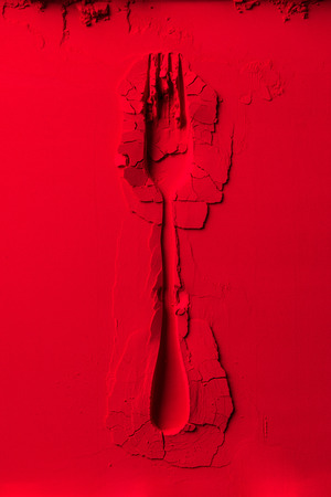 top view of shape of fork on red powder