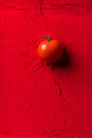 top view of red tomato on red powderの写真素材