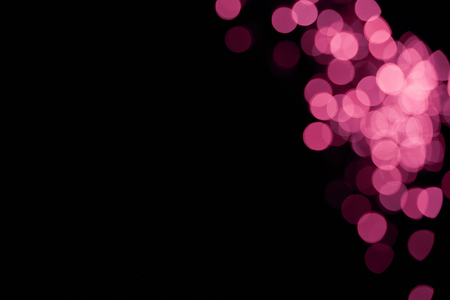 beautiful pink shiny defocused bokeh on black backgroundの写真素材