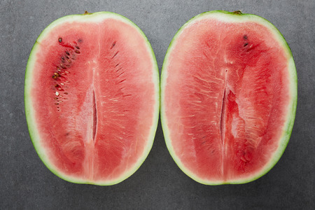 top view of ripe watermelon pieces on grey concrete tabletopの写真素材