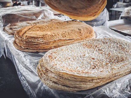 stacks of lavash bread selling on farmers market at Armeniaの写真素材
