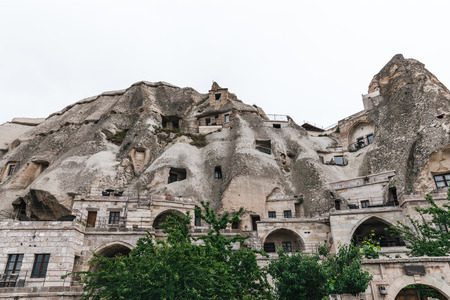 low angle view of beautiful rock formations and buildings in cappadocia, turkeyの写真素材