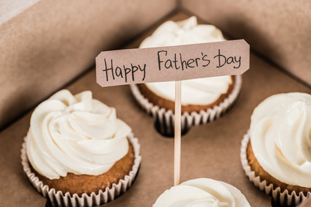 close-up shot of tasty cupcakes in box with Happy fathers day inscriptionの写真素材