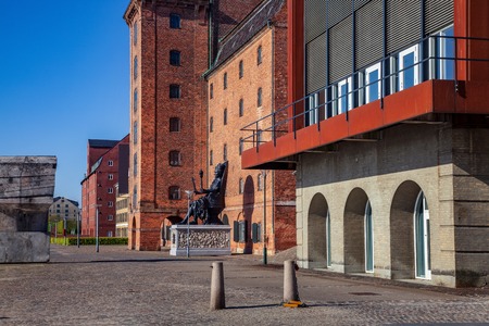 historical statue on pavement near buildings on empty street in copenhagen, denmarkの写真素材