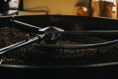 Roasting coffee beans in large coffee roasterの写真素材