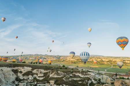 front view of colorful hot air balloons flying over city in Cappadocia, Turkeyの写真素材