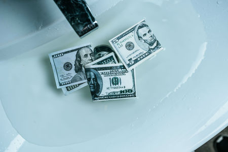 elevated view of dollar banknotes in water in sinkの写真素材