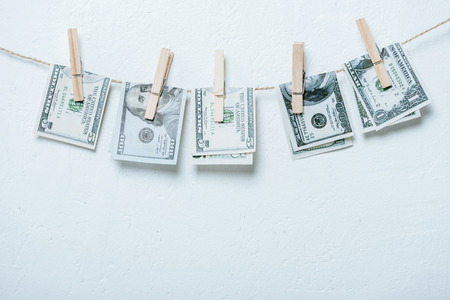 dollar banknotes hanging on rope isolated on greyの写真素材