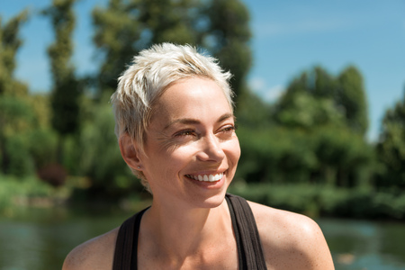 portrait of beautiful smiling woman looking away in park