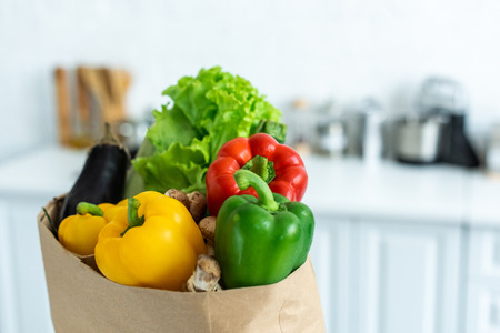 close-up view of grocery bag with fresh healthy vegetablesの写真素材
